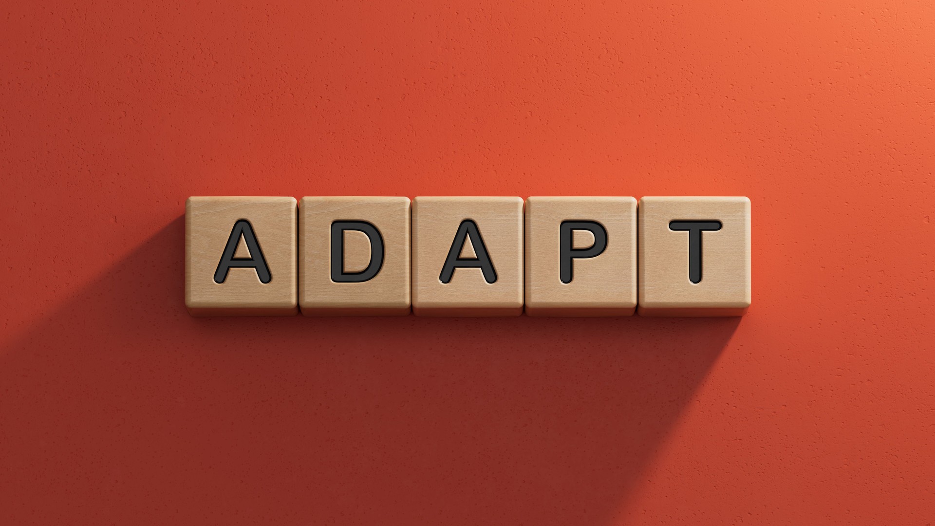 Adapt symbol. The concept word 'adapt' on wooden cubes. Business, adaptation and adapt concept.Business Concept.3D rendering on red background.